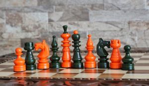 Orange and green wooden chess pieces 