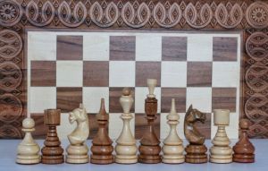 Walnut chess board with chess pieces and backgammon