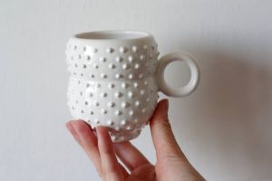 White symmetrical ceramic cup