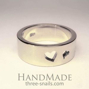 Silver ring with perforating hearts