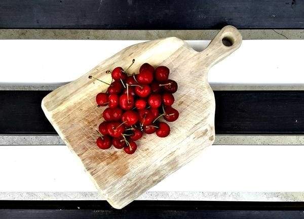 wooden cut board with cherries